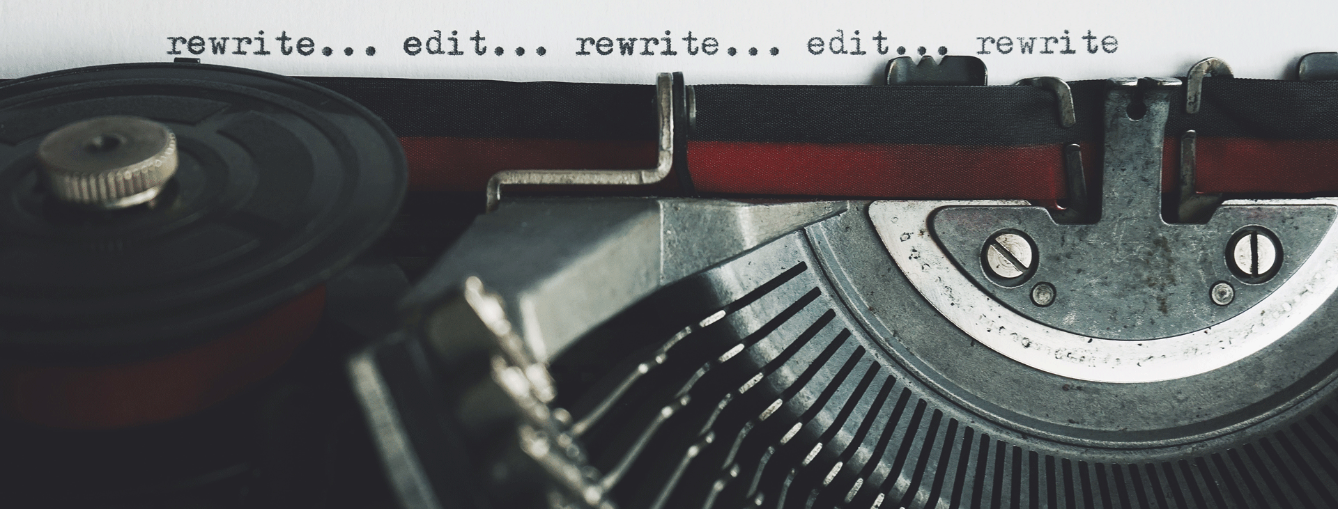 Old typewriter with paper that says edit .. rewrite ... write
