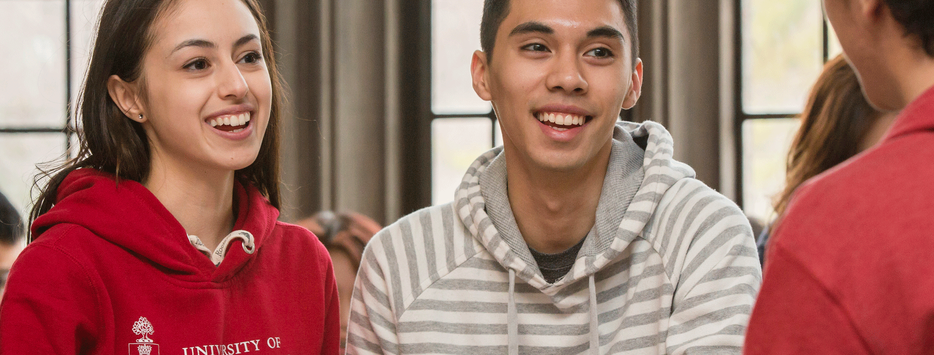 Two students talking to a staff member