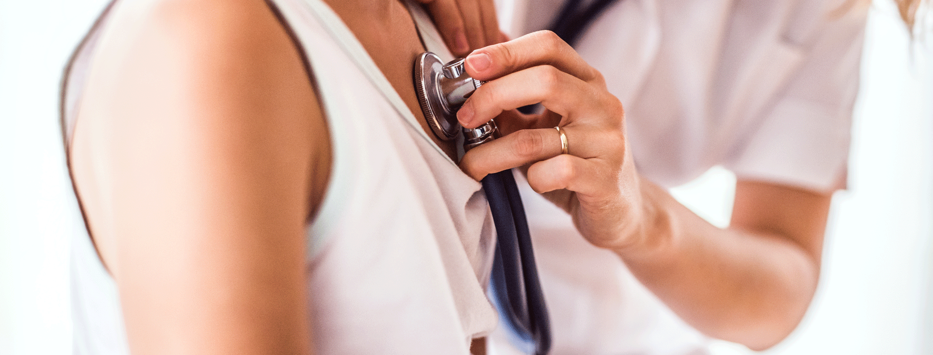 Doctor places stethoscope on patient chest