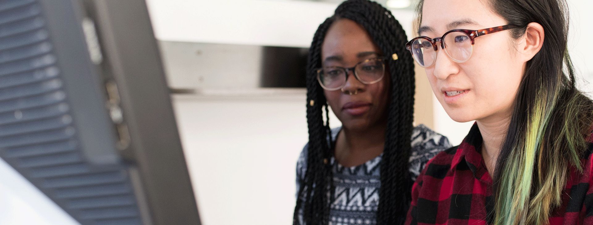 Student and staff mentee looking at computer screen