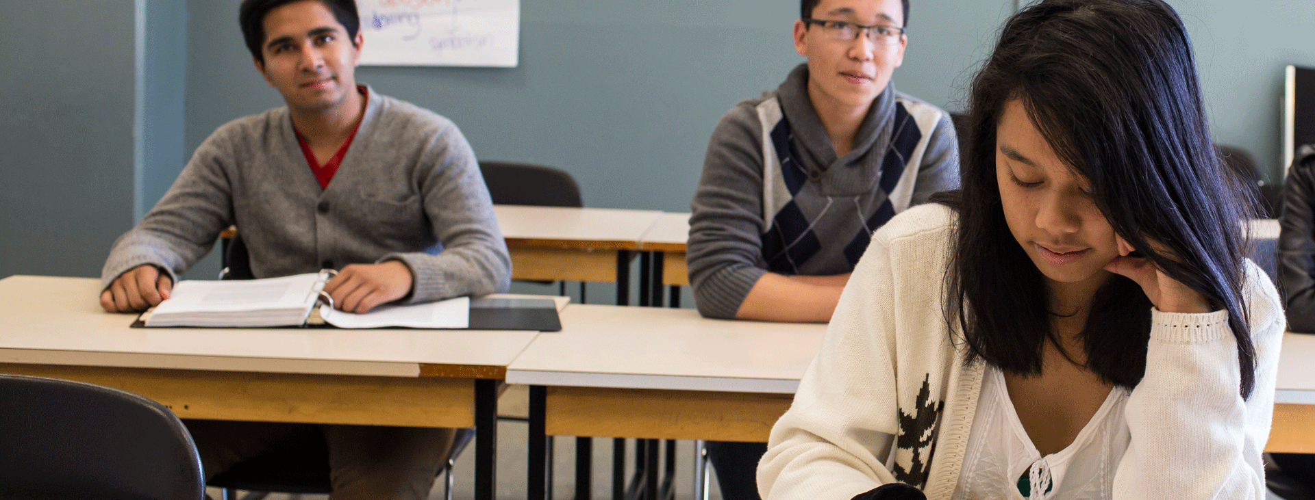 Three students taking exams