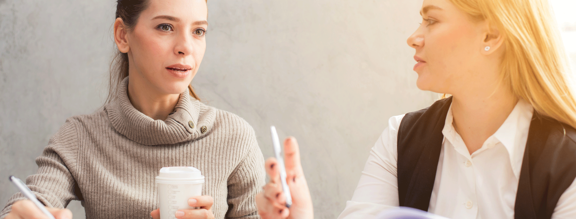 Two women having a conversation at a workshop