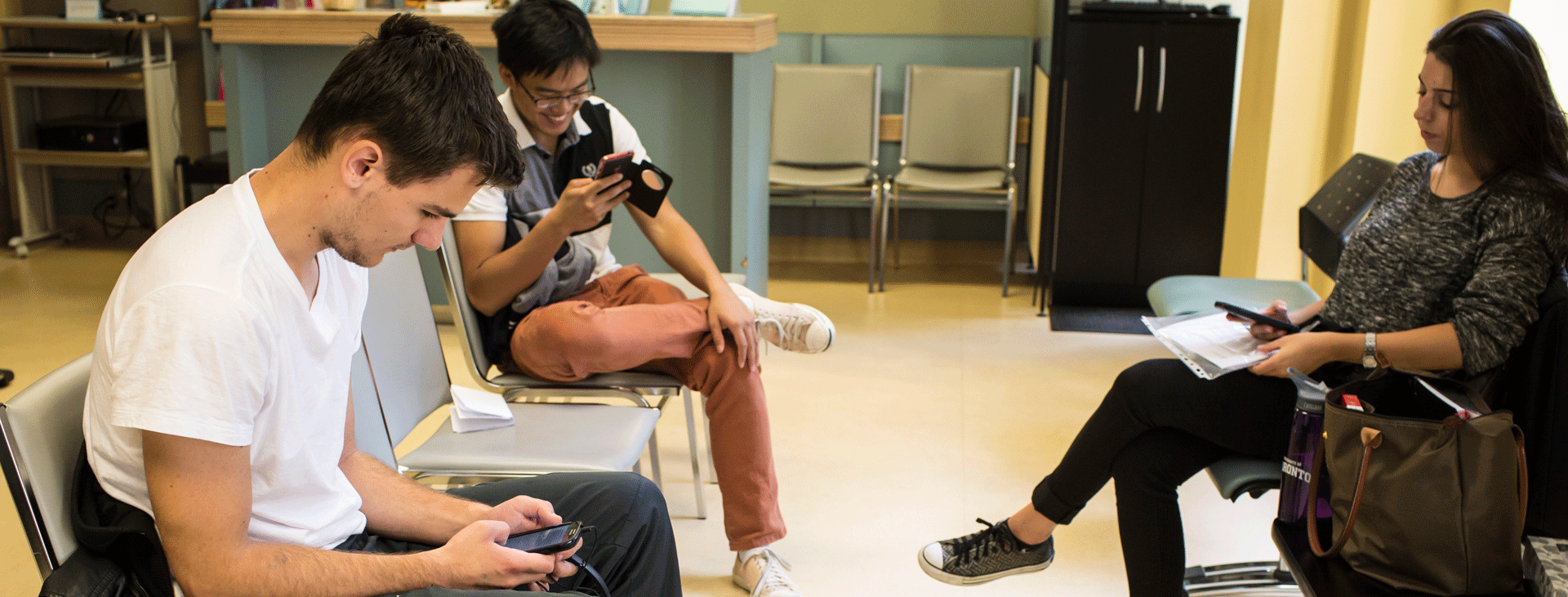 3 students sitting in Health and Wellness reception